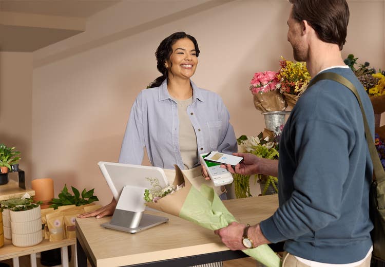 man paying at flower shop