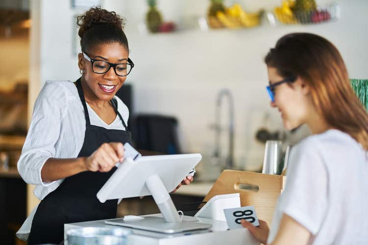 Employee making a sale on a Clover Station Duo POS