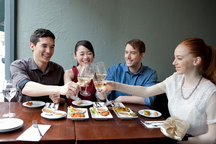 People raising a toast with wine glasses