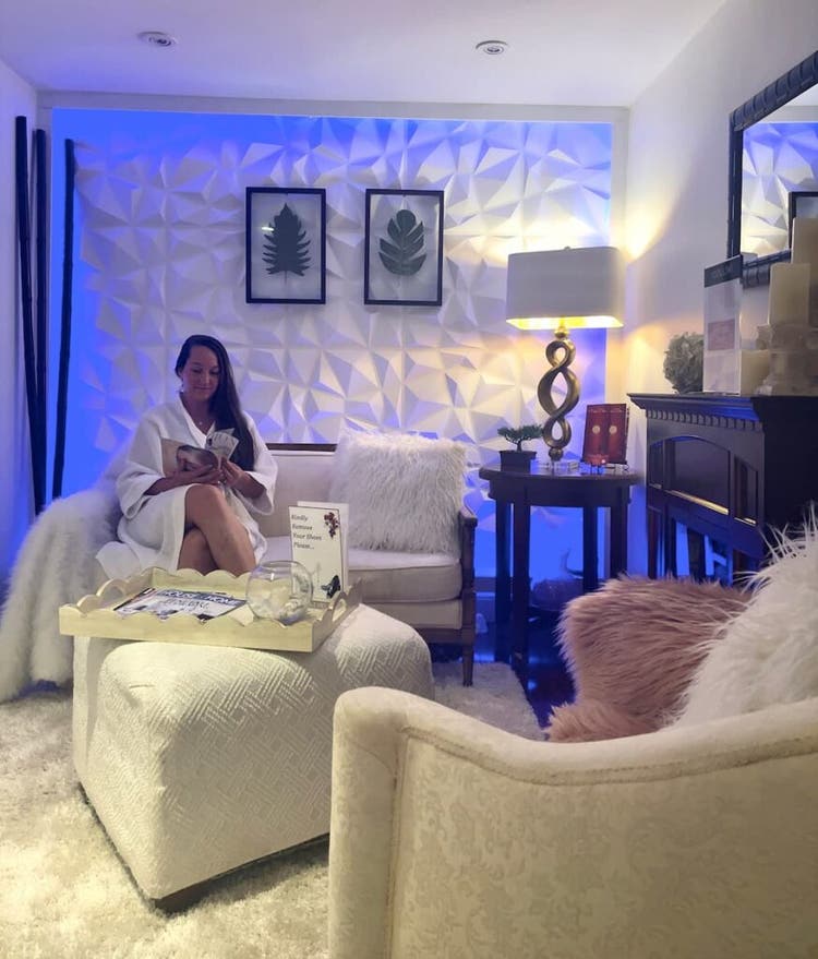 Woman sitting in chair at La Peau D'or Beauty Wellness Spa