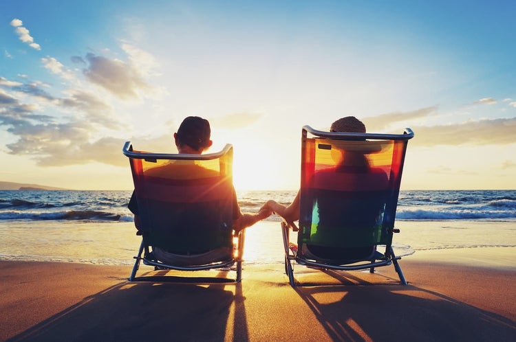 Couple holding hands on the beach