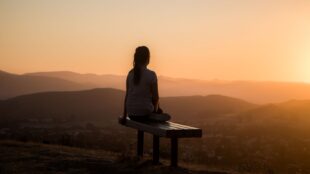 Woman on bench looking at horizon