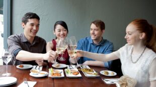 People raising a toast with wine glasses