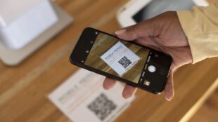 Person scanning a QR code with a smart phone