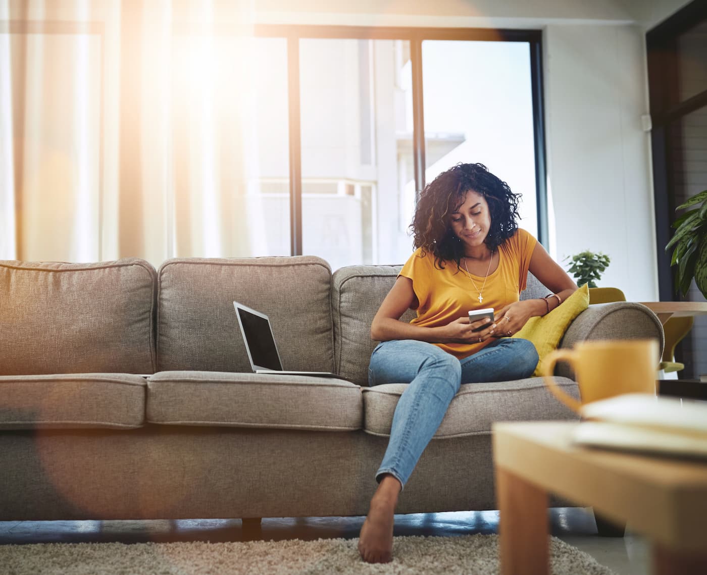 Woman sitting on the couch looking at her phone