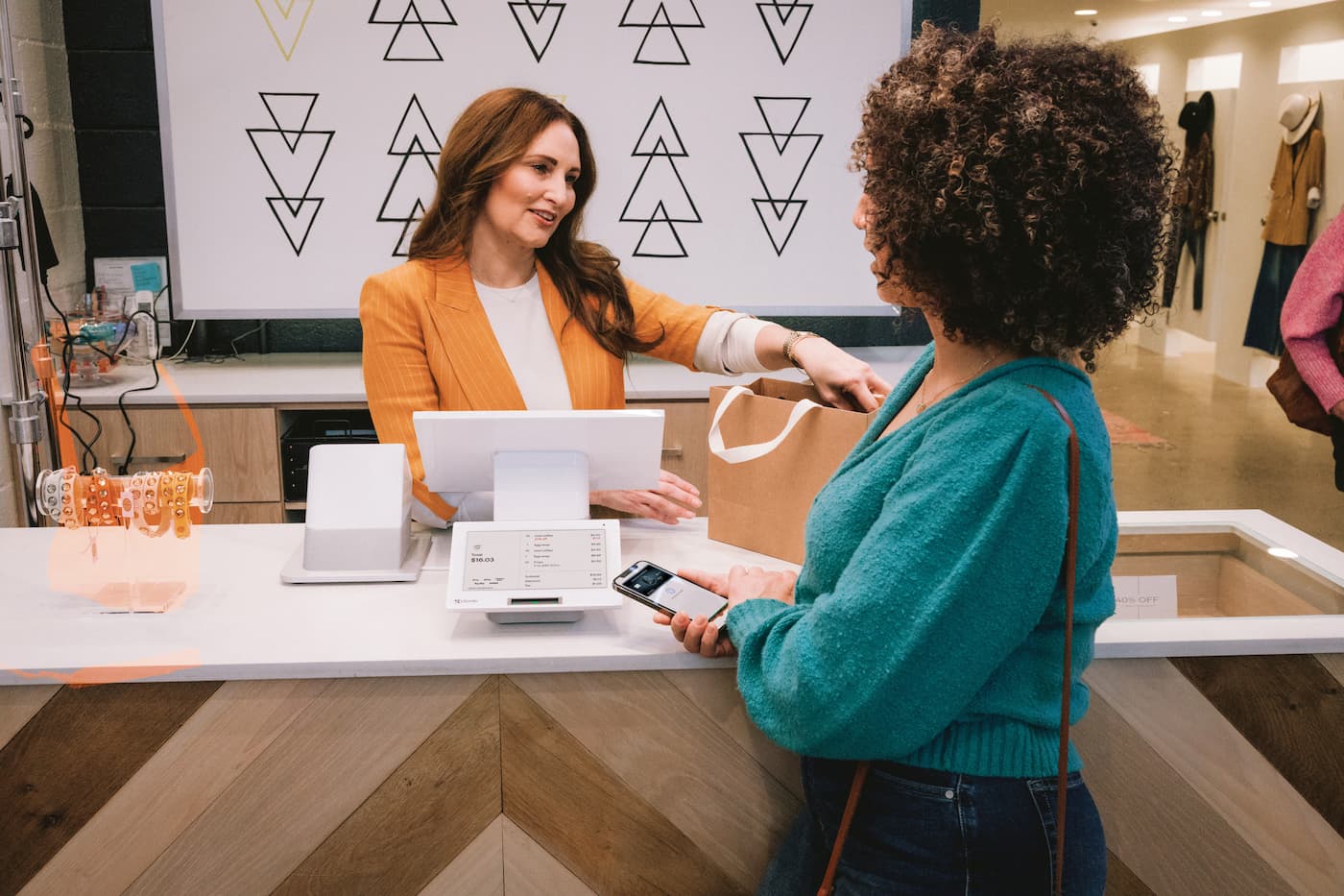 Woman making payment at a retail store on a Clover Station Duo POS