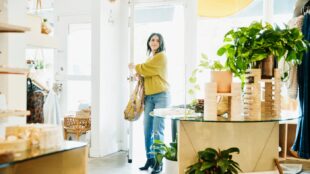 Woman walking into a retail store.