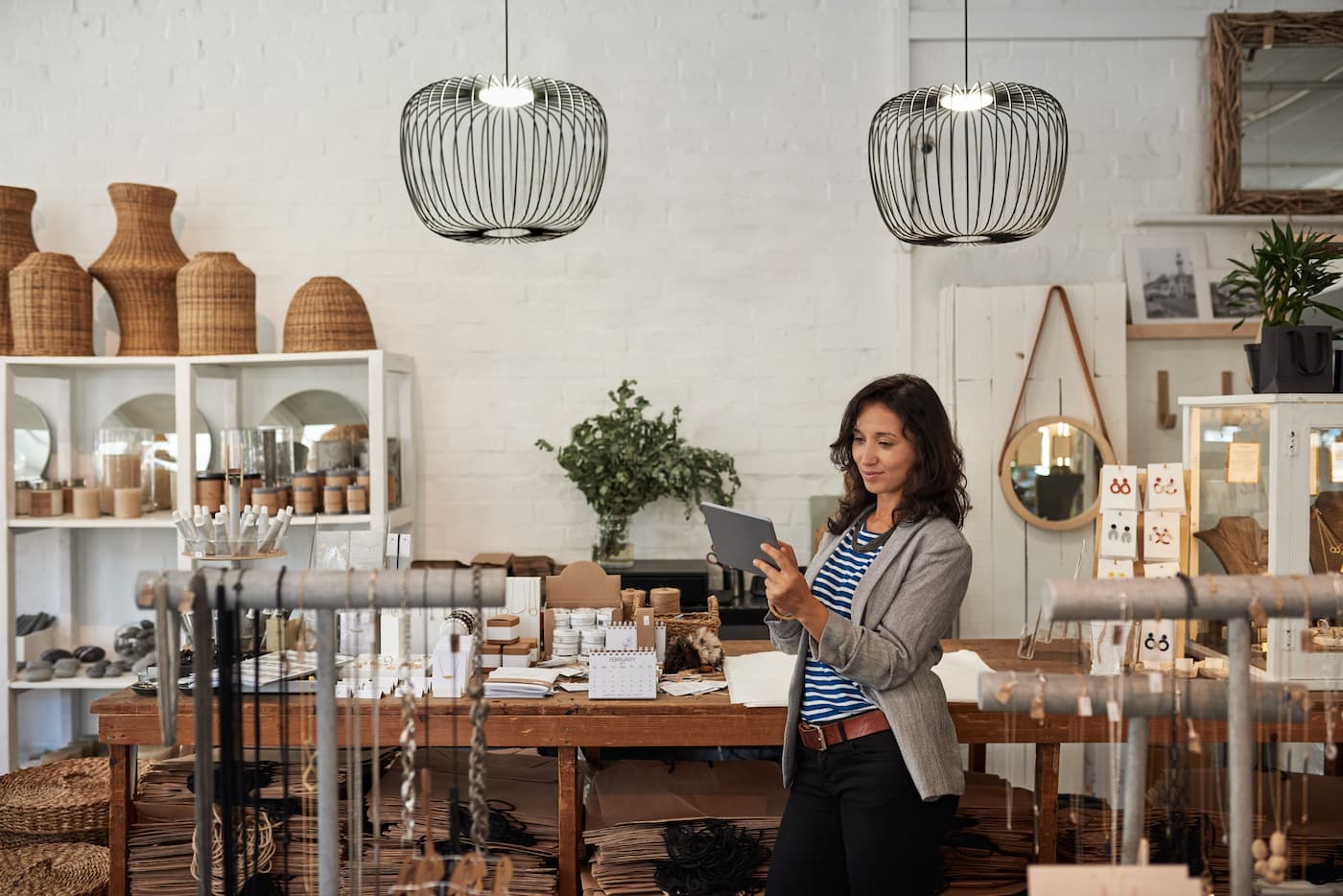 woman looking at tablet in boutique