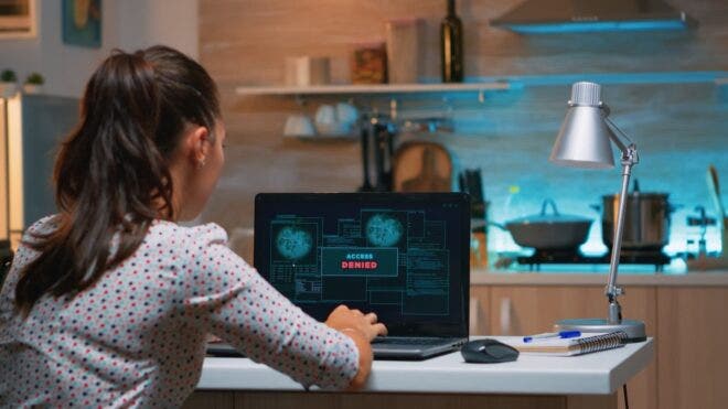Woman on laptop with access denied message