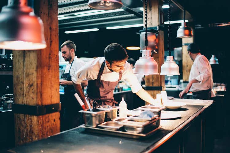 Three chefs working in kitchen