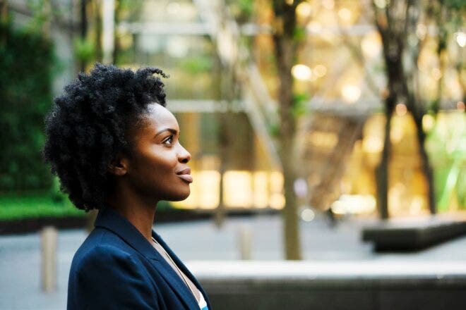 Woman sitting outside looking hopeful