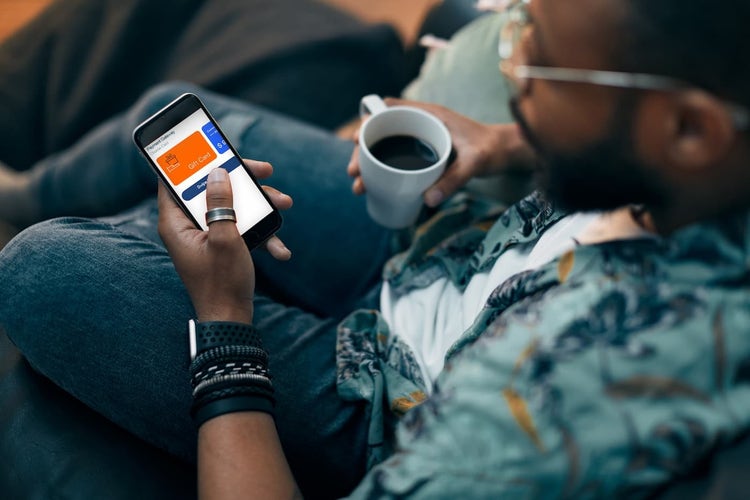 Man making purchase on mobile with digital gift card