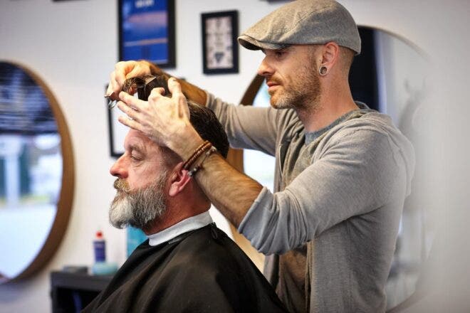 Barber cutting man's hair