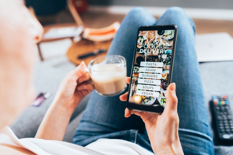 Holding coffee and mobile phone