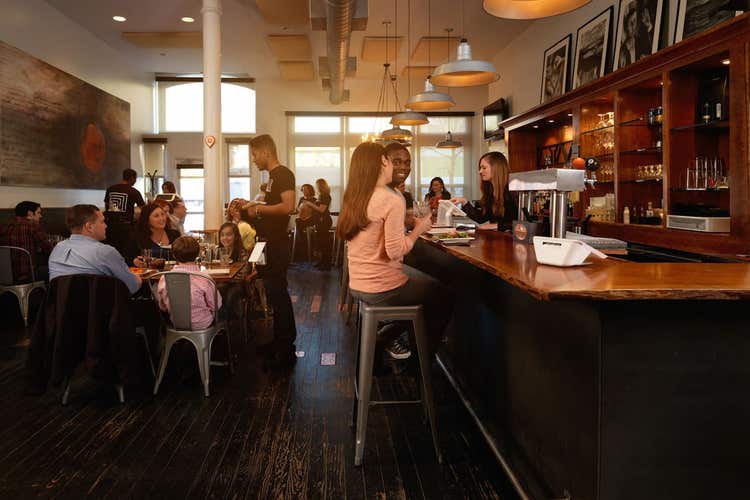 People dining at casual restaurant with bar