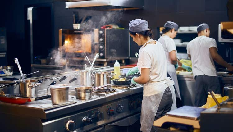 cooks making food in full service restaurant kitchen