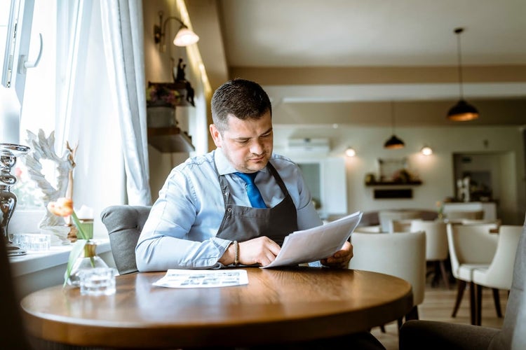 Restaurant manager looking at papers