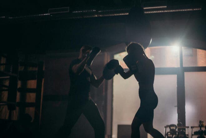 Personal trainer conducting boxing workout with female client