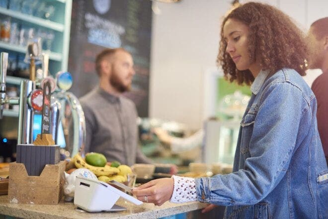 Woman making contactless card payment on Clover Mini