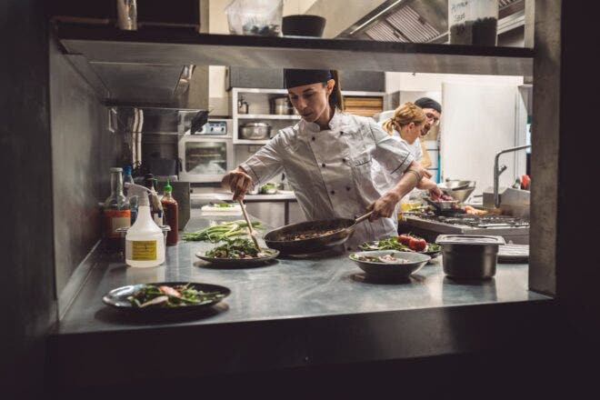 Female chef plating meal