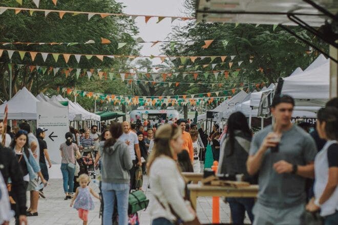 People walking through outdoor market event