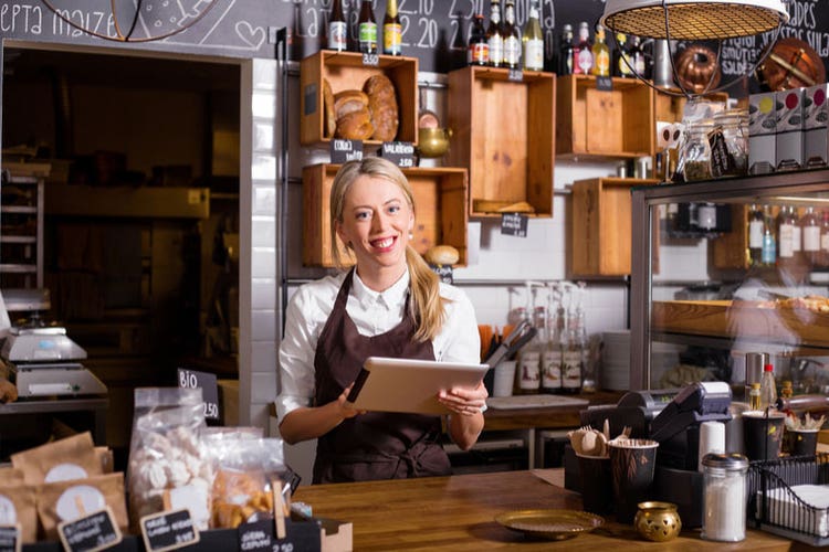 Shopkeeper holding tablet