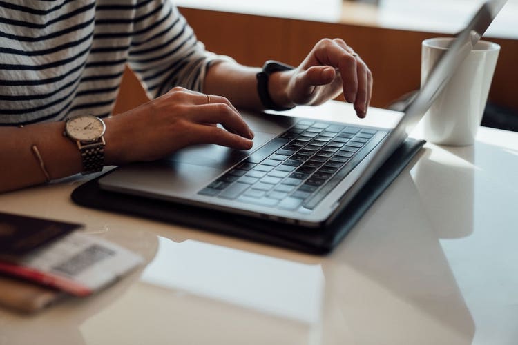 Hands typing on PC
