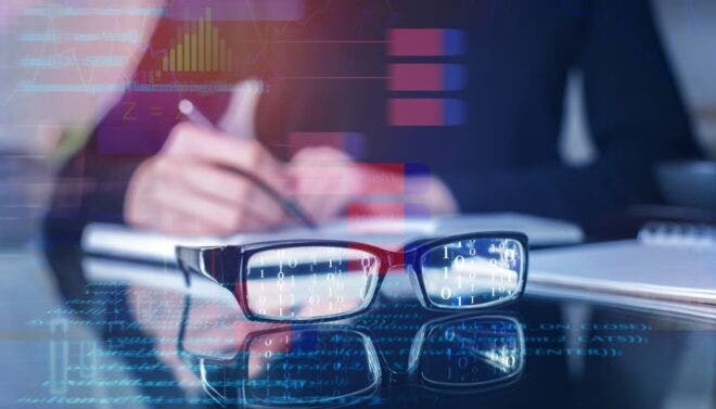 Glasses with code on desk