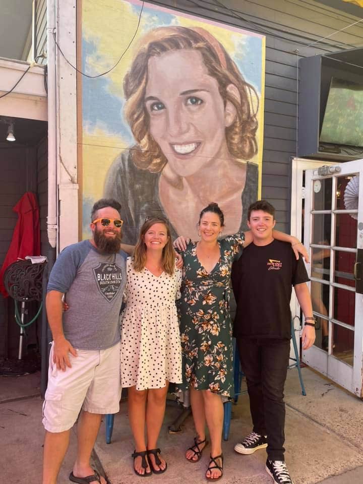 Family in front of painting of Mary