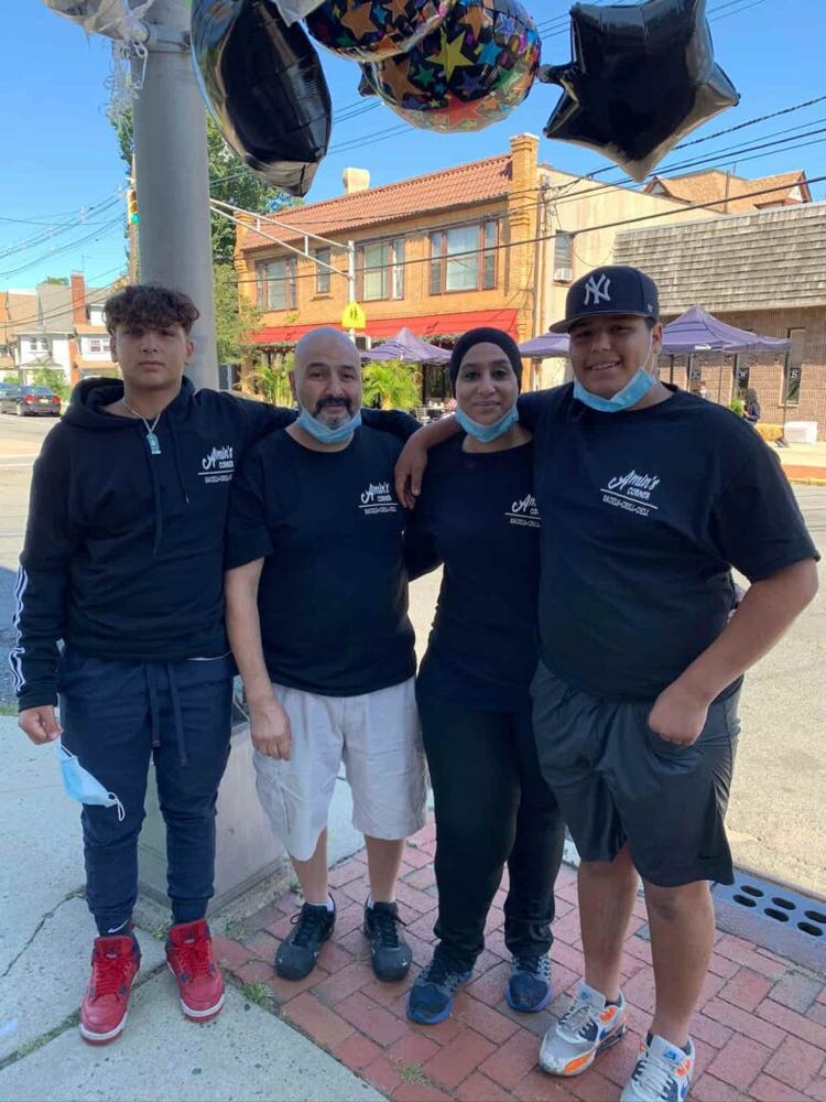 owner of amin's corner with staff