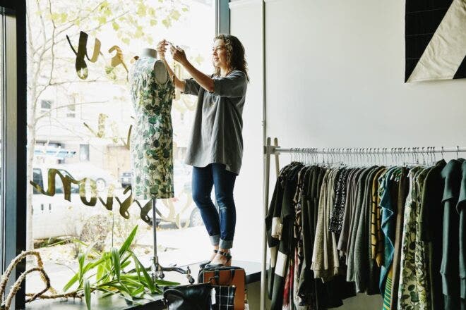Woman dressing clothing form at boutique