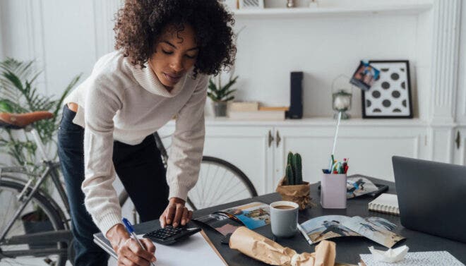 Woman writing on clipboard