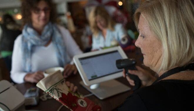 Cashier scanning towel