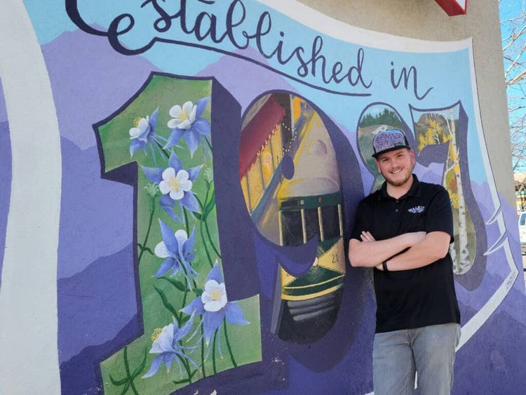 GM of Walrus Ice Cream in front of mural