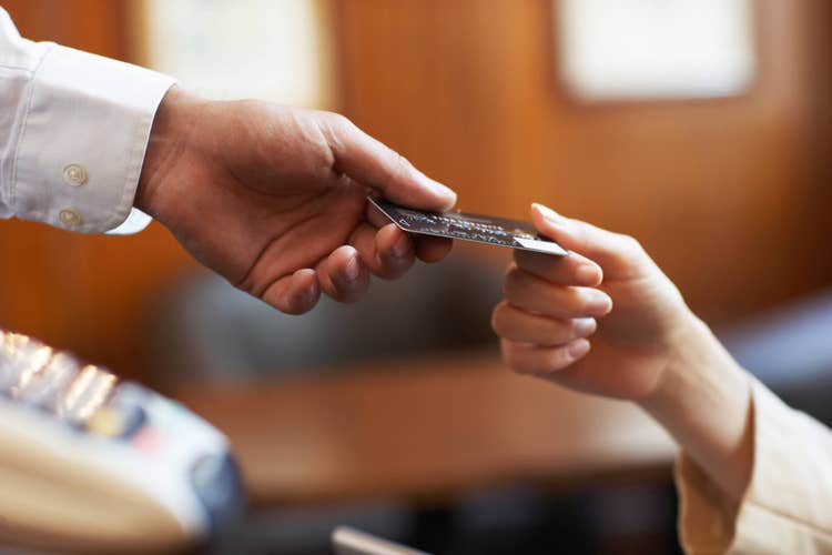 Hands exchanging credit card