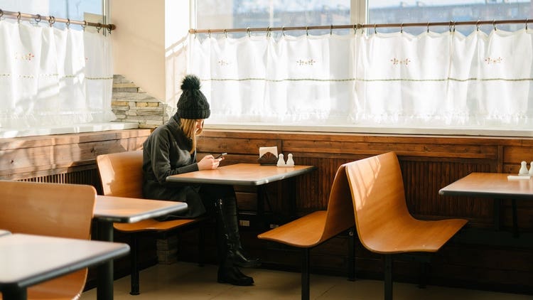 Woman sitting in restaurant booth