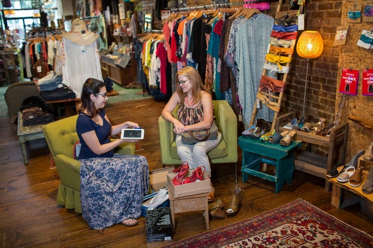 Customer purchasing shoes from boutique