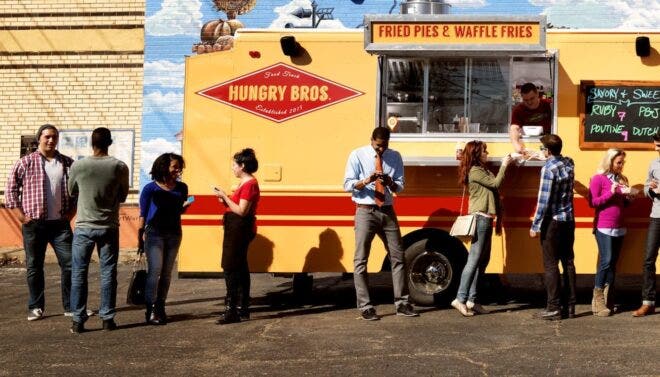 People standing in front of food truck