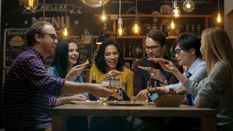 People eating pizza at restaurant