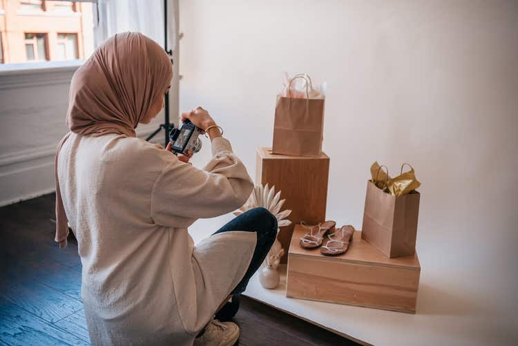 Woman taking pictures of shoes