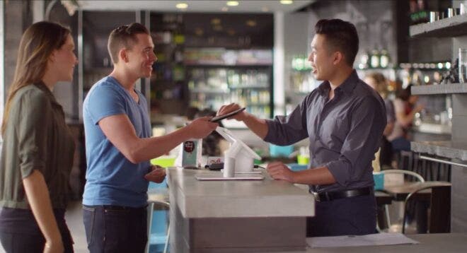 Couple redeeming gift card at shop