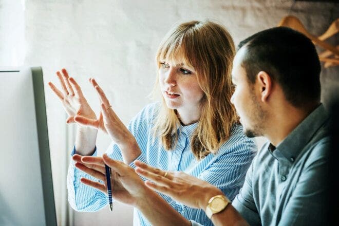 Two people talking with their hands