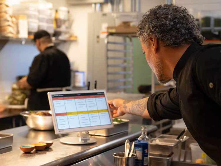 Chef looking at Clover KDS system