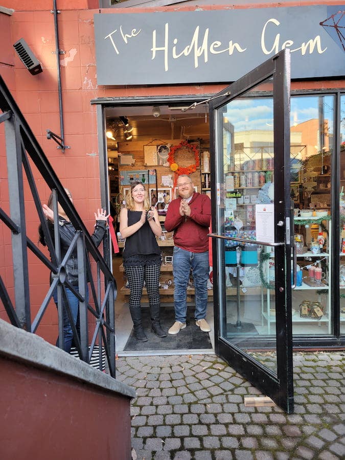 Hidden Gem owners standing in front entrance of store