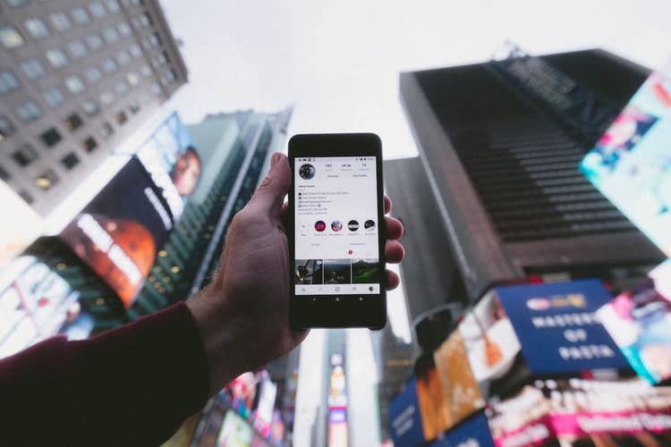 Holding phone in Times Square