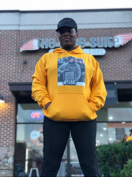 Owner of The Wing Suite wearing sweatshirt merch