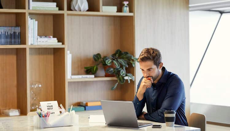 Man looking contemplative at laptop