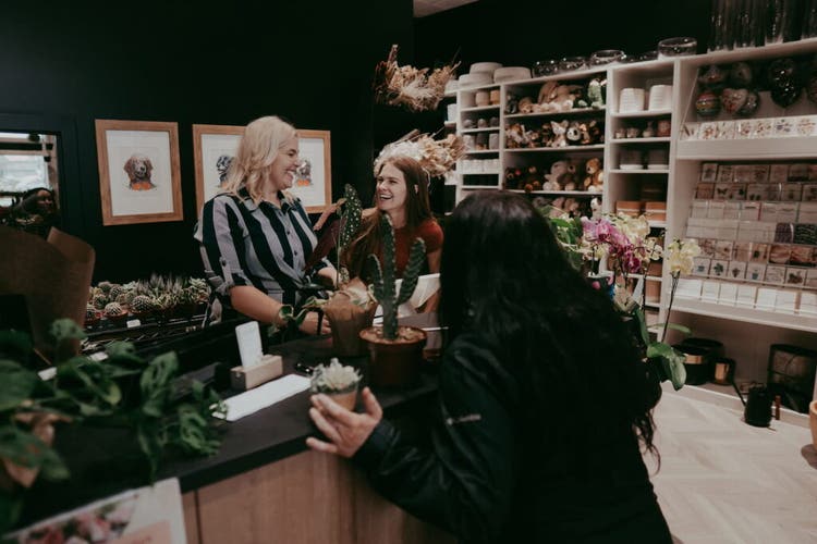 Owner of 3B's Flowers talking with others in her store
