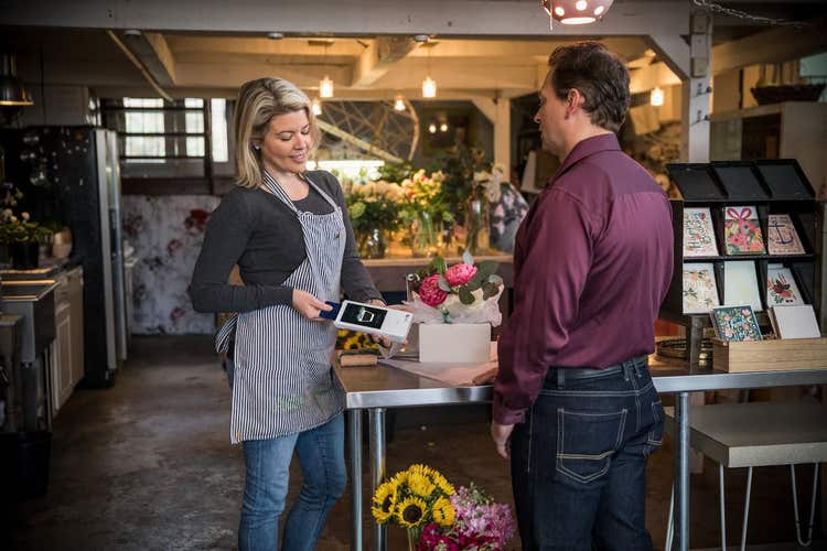 Florist processing credit card with Clover Flex