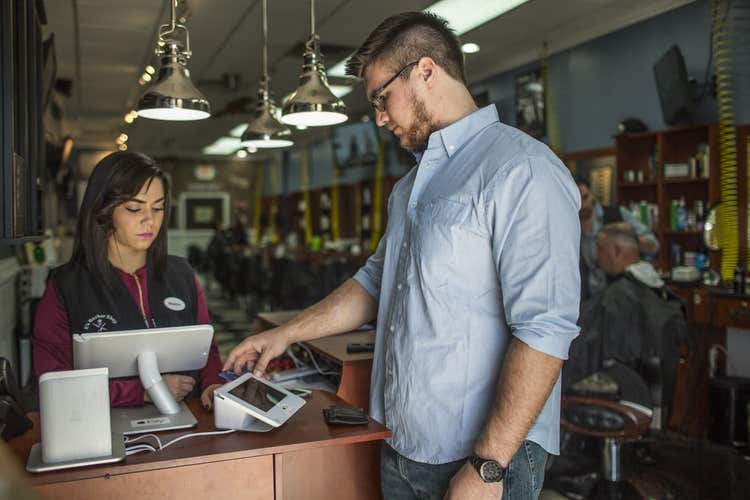 Customer inserting credit card into Clover Mini